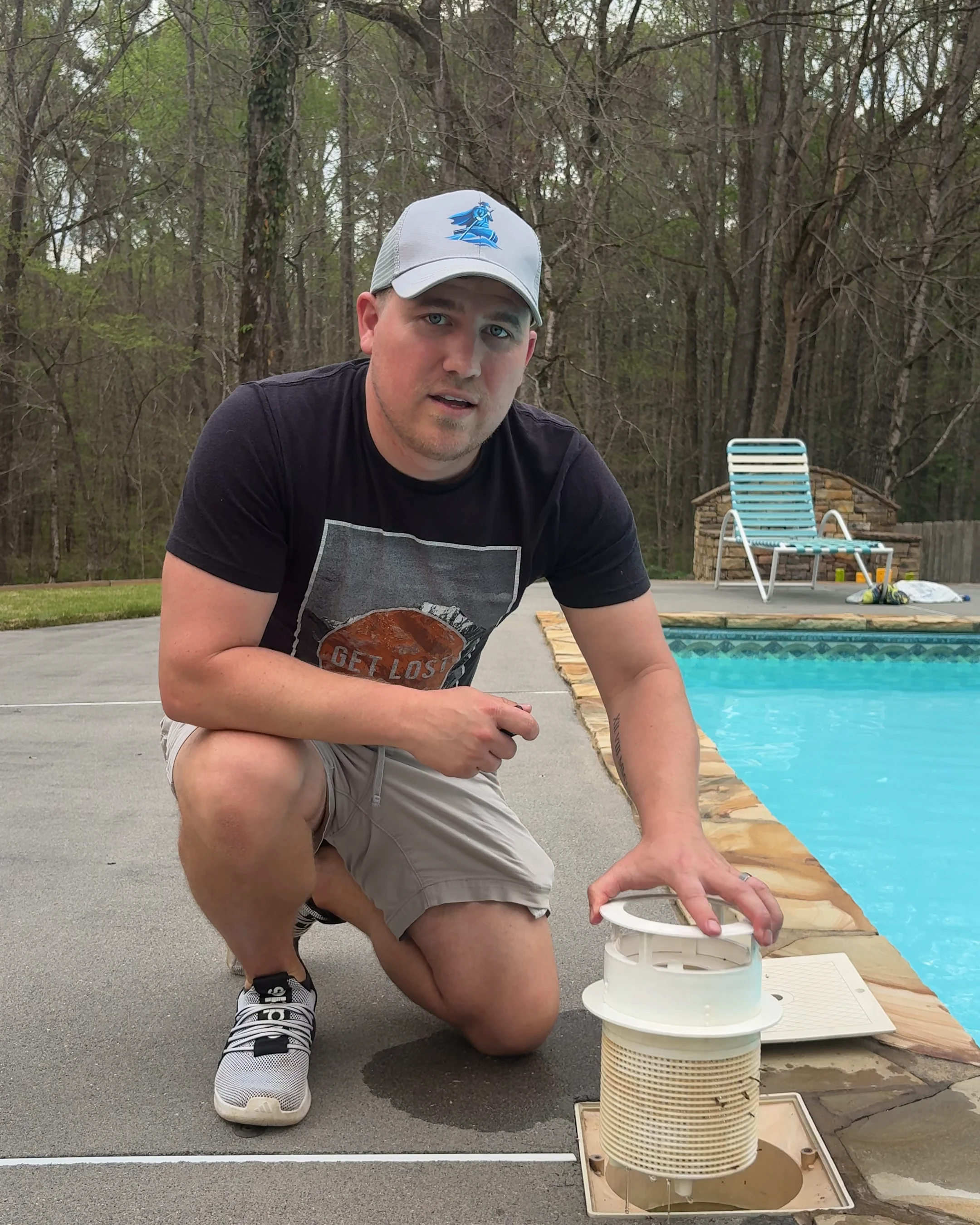 Corey Adams, co-founder of Pool Founder, pulling up a skimmer basket